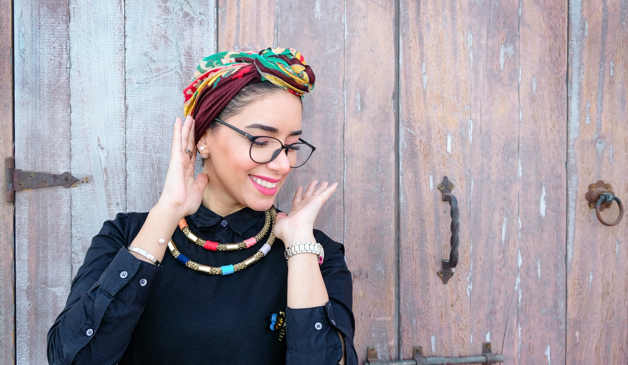 happy woman in front of wooden door